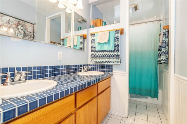 7744 Rhea Ave, Reseda, CA 91335 - bathroom featuring double vanity, tile patterned flooring, a wainscoted wall, and a decorative wall