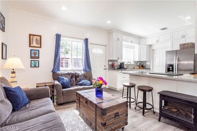 7744 Rhea Ave, Reseda, CA 91335 - living area featuring light wood-style flooring, ornamental molding, and recessed lighting