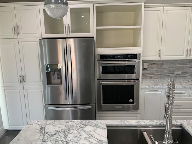 18810 Oakview Way, Lake Elsinore, CA 92530 - kitchen featuring appliances with stainless steel finishes, light stone counters, white cabinetry, and glass insert cabinets
