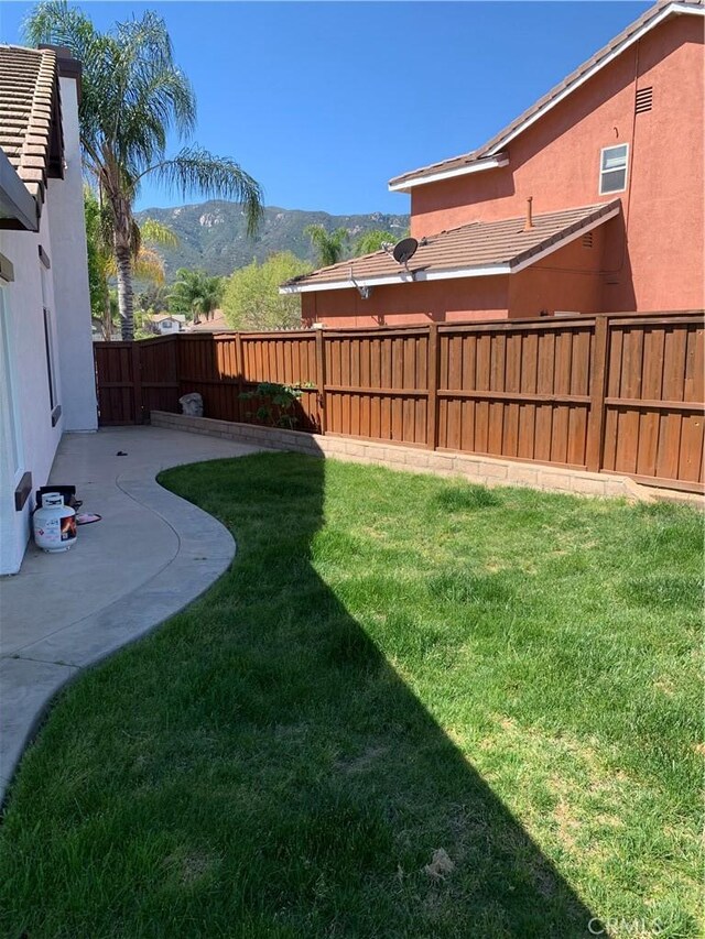 18810 Oakview Way, Lake Elsinore, CA 92530 - fenced backyard featuring a patio area and a mountain view