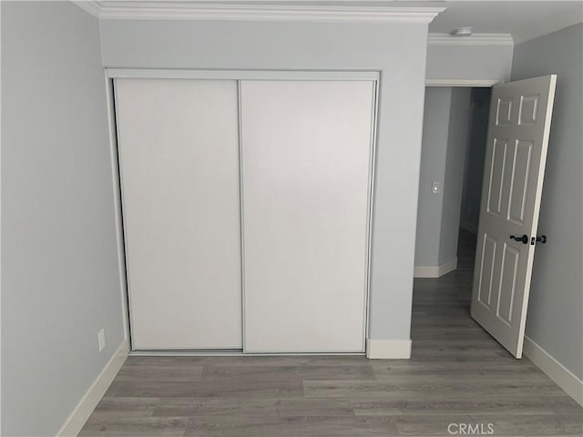 18810 Oakview Way, Lake Elsinore, CA 92530 - unfurnished bedroom featuring crown molding, a closet, and wood finished floors