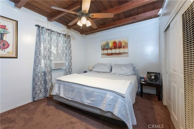 carpeted bedroom featuring baseboards, beamed ceiling, a ceiling fan, a closet, and wooden ceiling