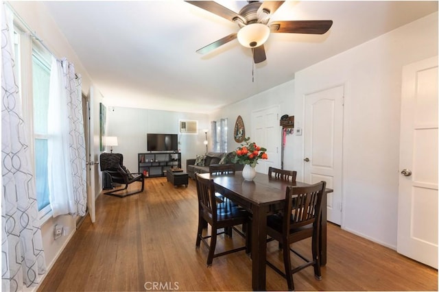 dining area with a ceiling fan and wood finished floors