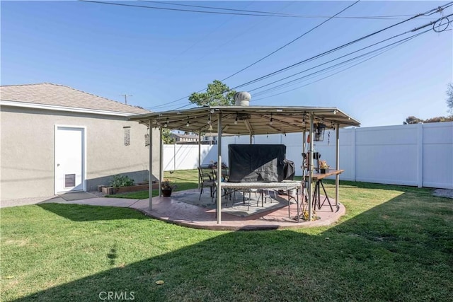 view of yard featuring a fenced backyard, a gazebo, and a patio area