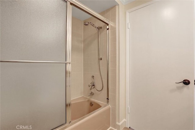 full bathroom featuring combined bath / shower with glass door