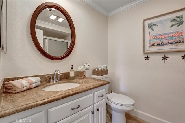bathroom with toilet, baseboards, ornamental molding, and vanity