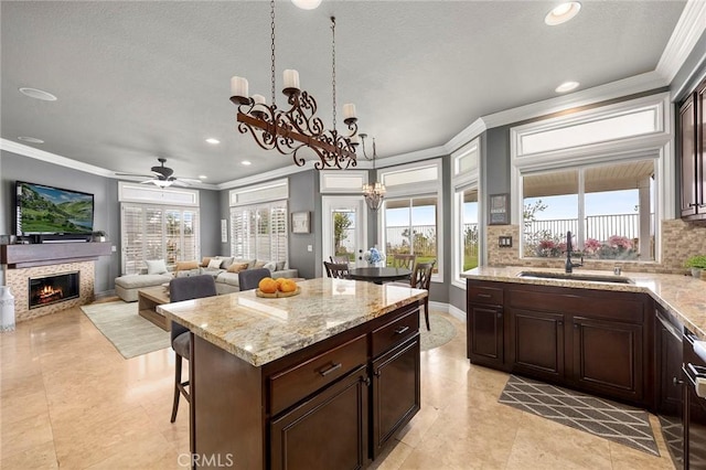 kitchen with recessed lighting, backsplash, crown molding, and a sink