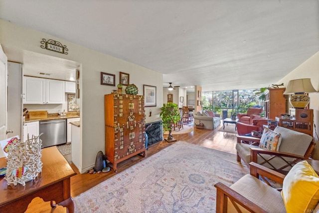 2564 Navarra Dr Unit 113, Carlsbad, CA 92009 - living area with wood finished floors, ceiling fan, and baseboards