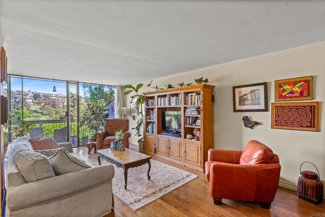 2564 Navarra Dr Unit 113, Carlsbad, CA 92009 - living room with wood finished floors and a wall of windows