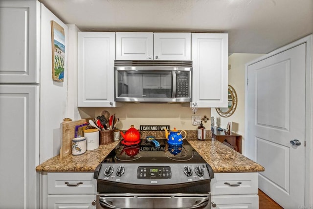 2564 Navarra Dr Unit 113, Carlsbad, CA 92009 - kitchen with stainless steel appliances, white cabinetry, and light stone countertops
