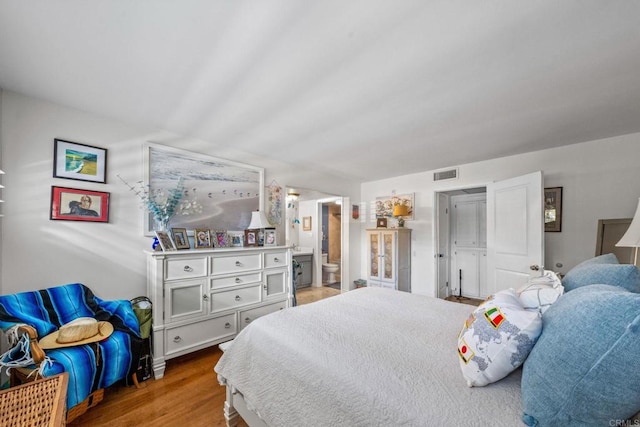 2564 Navarra Dr Unit 113, Carlsbad, CA 92009 - bedroom with wood finished floors and ensuite bathroom