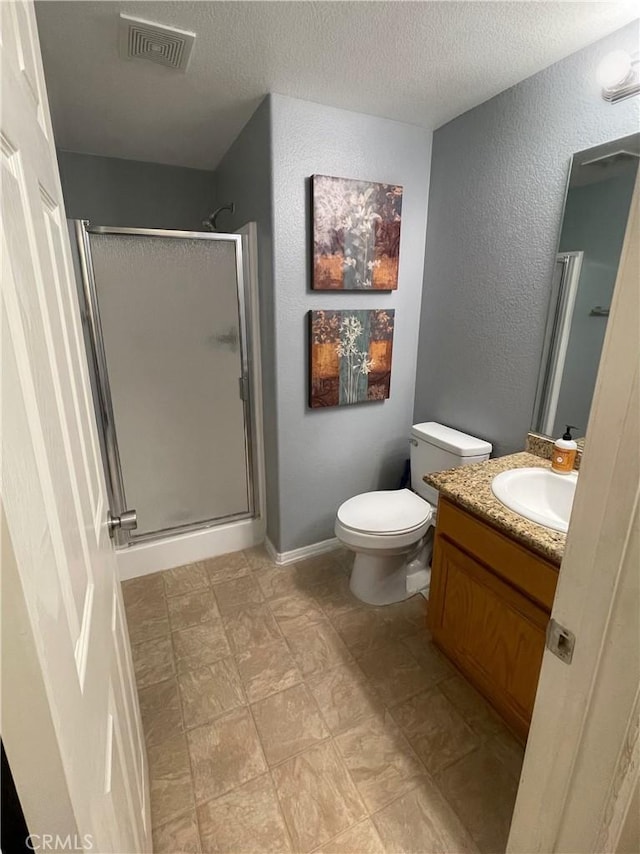 37016 Sabal Ave, Palmdale, CA 93552 - full bath with a stall shower, a textured ceiling, vanity, a textured wall, and toilet