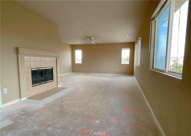 37016 Sabal Ave, Palmdale, CA 93552 - unfurnished living room featuring plenty of natural light, baseboards, a ceiling fan, and a fireplace