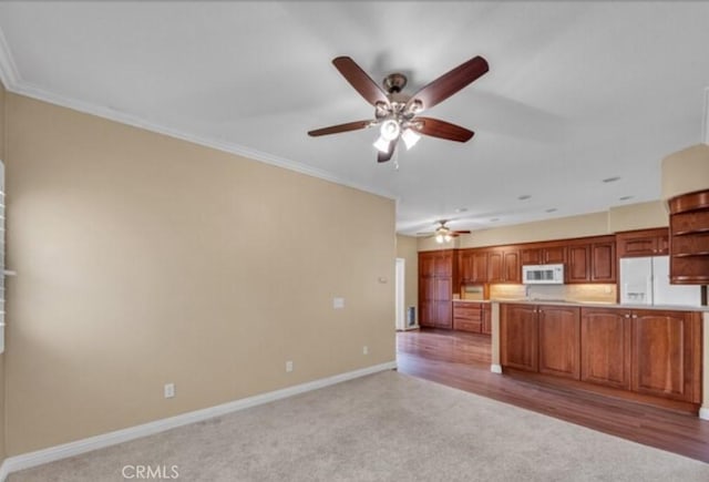 49 El Cencerro, Rancho Santa Margarita, CA 92688 - kitchen with baseboards, a ceiling fan, light carpet, and white appliances