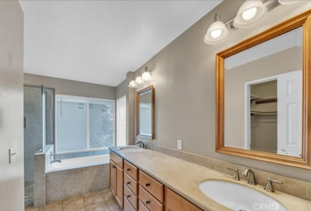 49 El Cencerro, Rancho Santa Margarita, CA 92688 - full bath with double vanity, a sink, a bath, and tile patterned floors