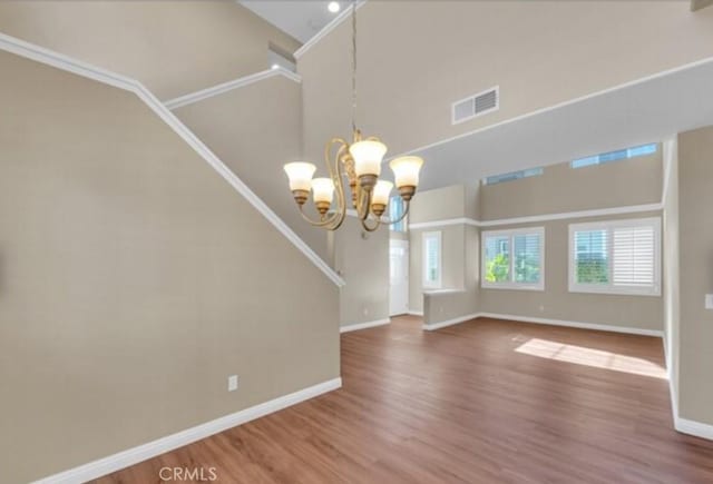 49 El Cencerro, Rancho Santa Margarita, CA 92688 - unfurnished dining area featuring a notable chandelier, visible vents, baseboards, and wood finished floors