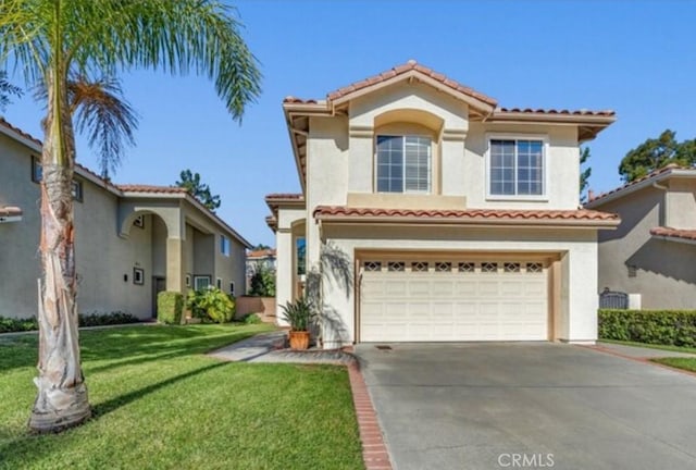 49 El Cencerro, Rancho Santa Margarita, CA 92688 - mediterranean / spanish-style home featuring an attached garage, a front lawn, a tile roof, stucco siding, and concrete driveway
