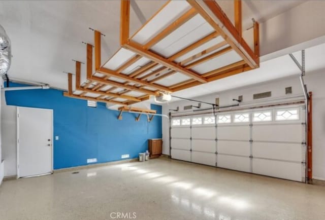 49 El Cencerro, Rancho Santa Margarita, CA 92688 - garage with baseboards and a garage door opener