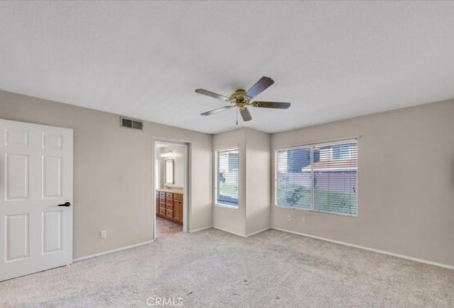 49 El Cencerro, Rancho Santa Margarita, CA 92688 - unfurnished bedroom featuring connected bathroom, light carpet, a ceiling fan, baseboards, and visible vents