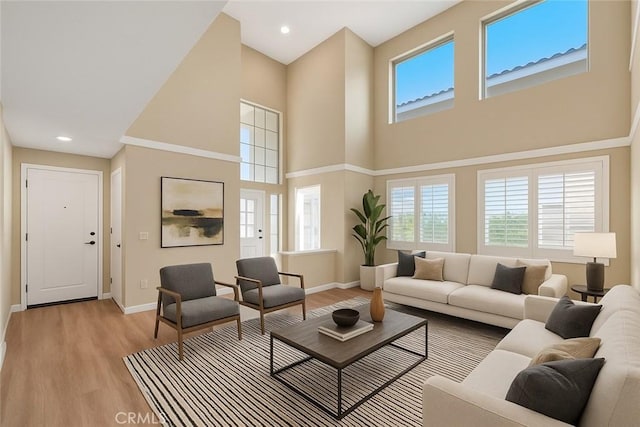 49 El Cencerro, Rancho Santa Margarita, CA 92688 - living room with baseboards, a high ceiling, and light wood-type flooring