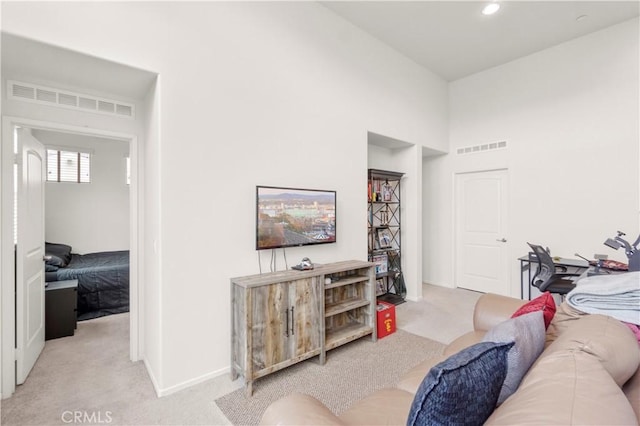 4250 W 5th St, Santa Ana, CA 92703 - living room featuring light carpet, visible vents, and a towering ceiling