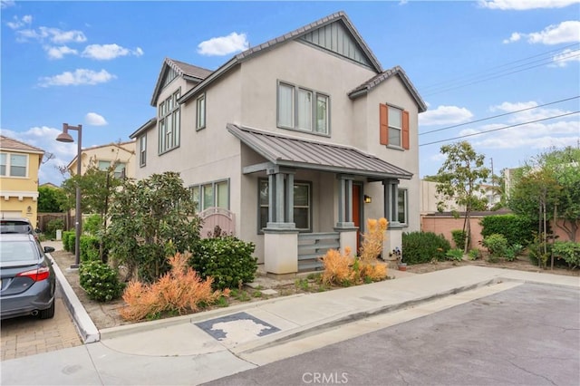 4250 W 5th St, Santa Ana, CA 92703 - view of front facade featuring stucco siding, fence, a standing seam roof, and metal roof