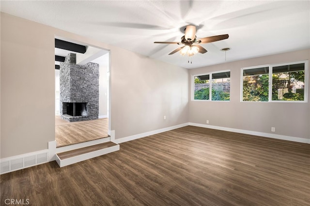 unfurnished living room featuring ceiling fan, baseboards, dark wood-type flooring, and visible vents
