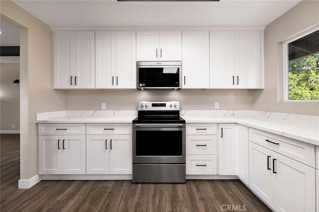 kitchen with white cabinets, stainless steel appliances, and dark wood-type flooring