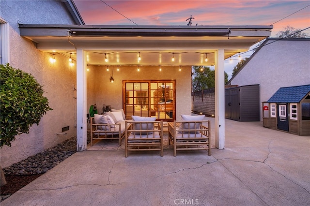 view of patio / terrace featuring an outbuilding, a shed, and an outdoor living space