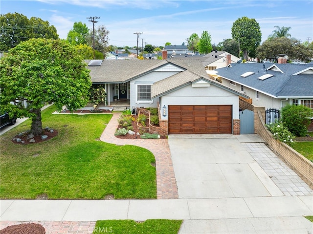 ranch-style home with a front lawn, driveway, a shingled roof, fence, and a garage