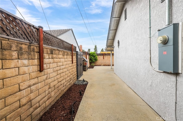 view of property exterior featuring stucco siding and fence