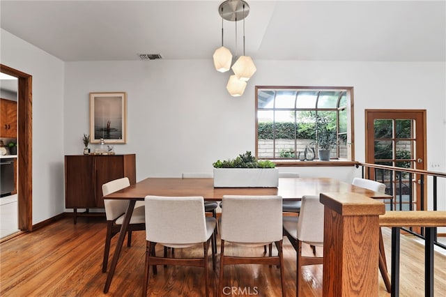 dining room with wood finished floors and visible vents