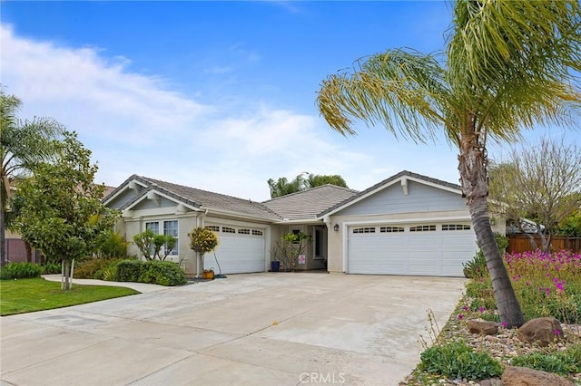 ranch-style house featuring a garage, stucco siding, driveway, and a tile roof
