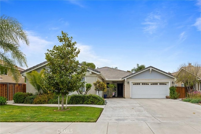 view of front facade with a garage, fence, concrete driveway, and a front lawn