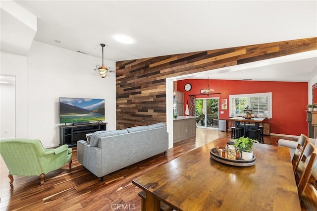 dining room featuring wood walls and wood finished floors