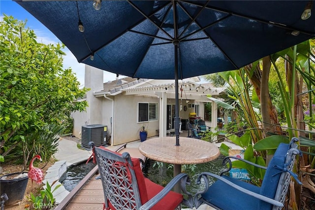 wooden terrace with central AC unit, a pergola, and a patio