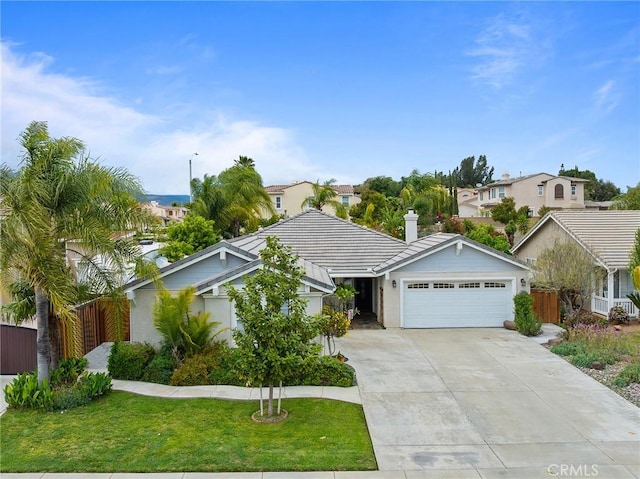 ranch-style home with fence, an attached garage, a front lawn, stucco siding, and concrete driveway