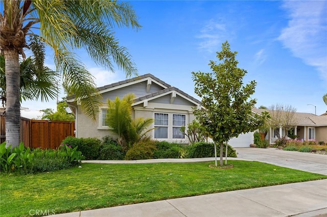 view of front of home featuring fence, an attached garage, a front lawn, stucco siding, and concrete driveway
