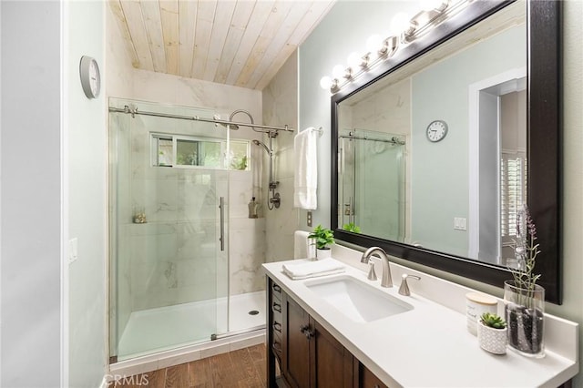 full bath featuring vanity, a stall shower, wooden ceiling, and wood finished floors