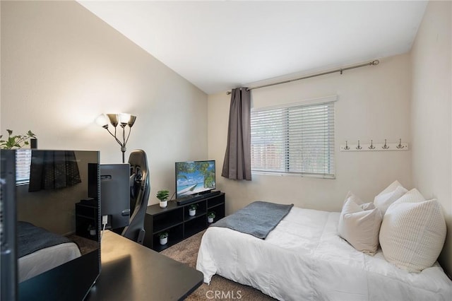 carpeted bedroom featuring lofted ceiling