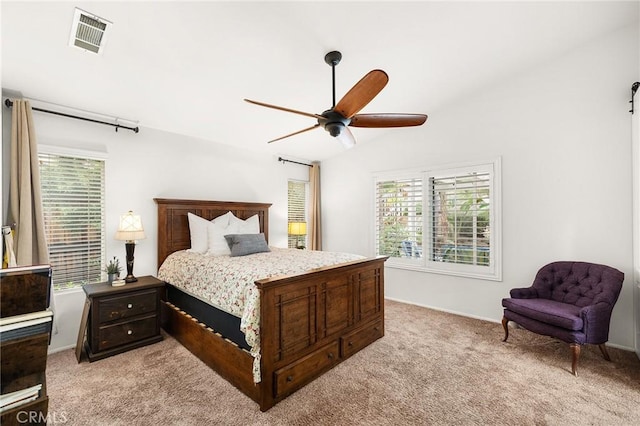 bedroom with visible vents, a ceiling fan, carpet floors, and multiple windows