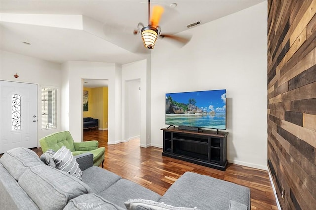 living area featuring a ceiling fan, visible vents, and wood finished floors