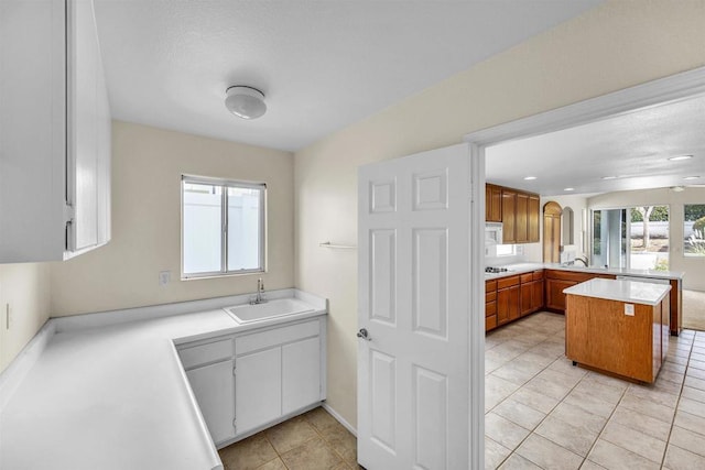 6017 Piros Way, Oceanside, CA 92056 - kitchen featuring a sink, light countertops, light tile patterned floors, and brown cabinetry