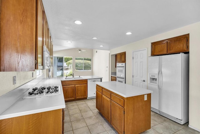 6017 Piros Way, Oceanside, CA 92056 - kitchen featuring light tile patterned floors, ceiling fan, brown cabinetry, and white appliances