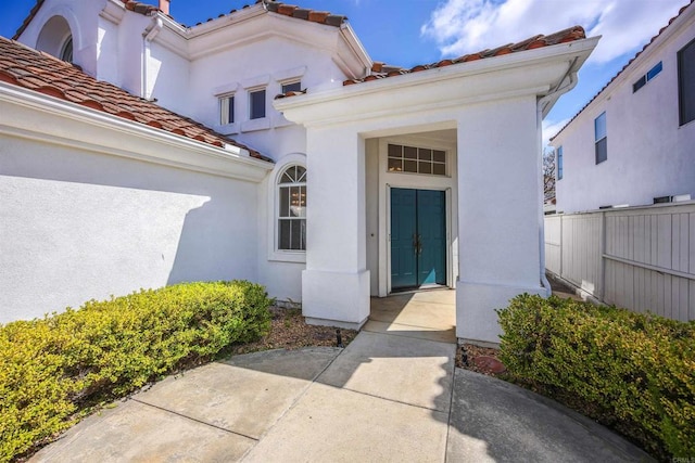 6017 Piros Way, Oceanside, CA 92056 - doorway to property featuring stucco siding, a tile roof, and fence