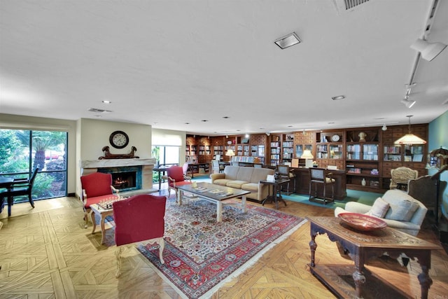 6017 Piros Way, Oceanside, CA 92056 - living area with track lighting, a high end fireplace, visible vents, and recessed lighting