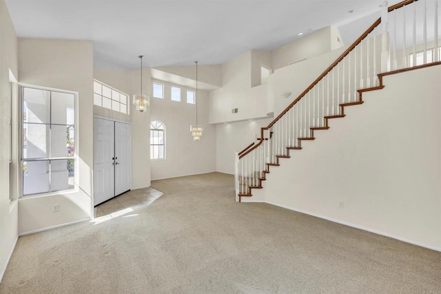 6017 Piros Way, Oceanside, CA 92056 - carpeted entrance foyer with stairway, a towering ceiling, baseboards, and a chandelier