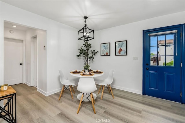 4301 W 138th St, Hawthorne, CA 90250 - dining room with wood finished floors, a chandelier, and baseboards