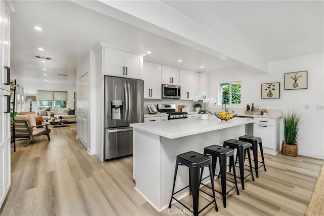 4301 W 138th St, Hawthorne, CA 90250 - kitchen featuring stainless steel appliances, light wood-type flooring, recessed lighting, white cabinets, and a breakfast bar