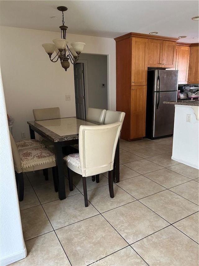 dining room with an inviting chandelier and light tile patterned floors